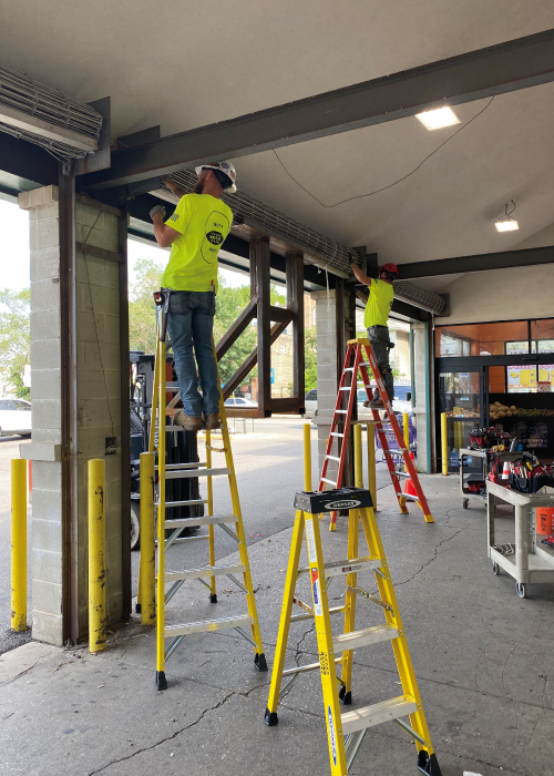 United Door and Dock Crew Members Working on Roll Up Door Installation