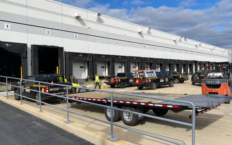 United Door and Dock Trucks Parked Outside Warehouse Docks