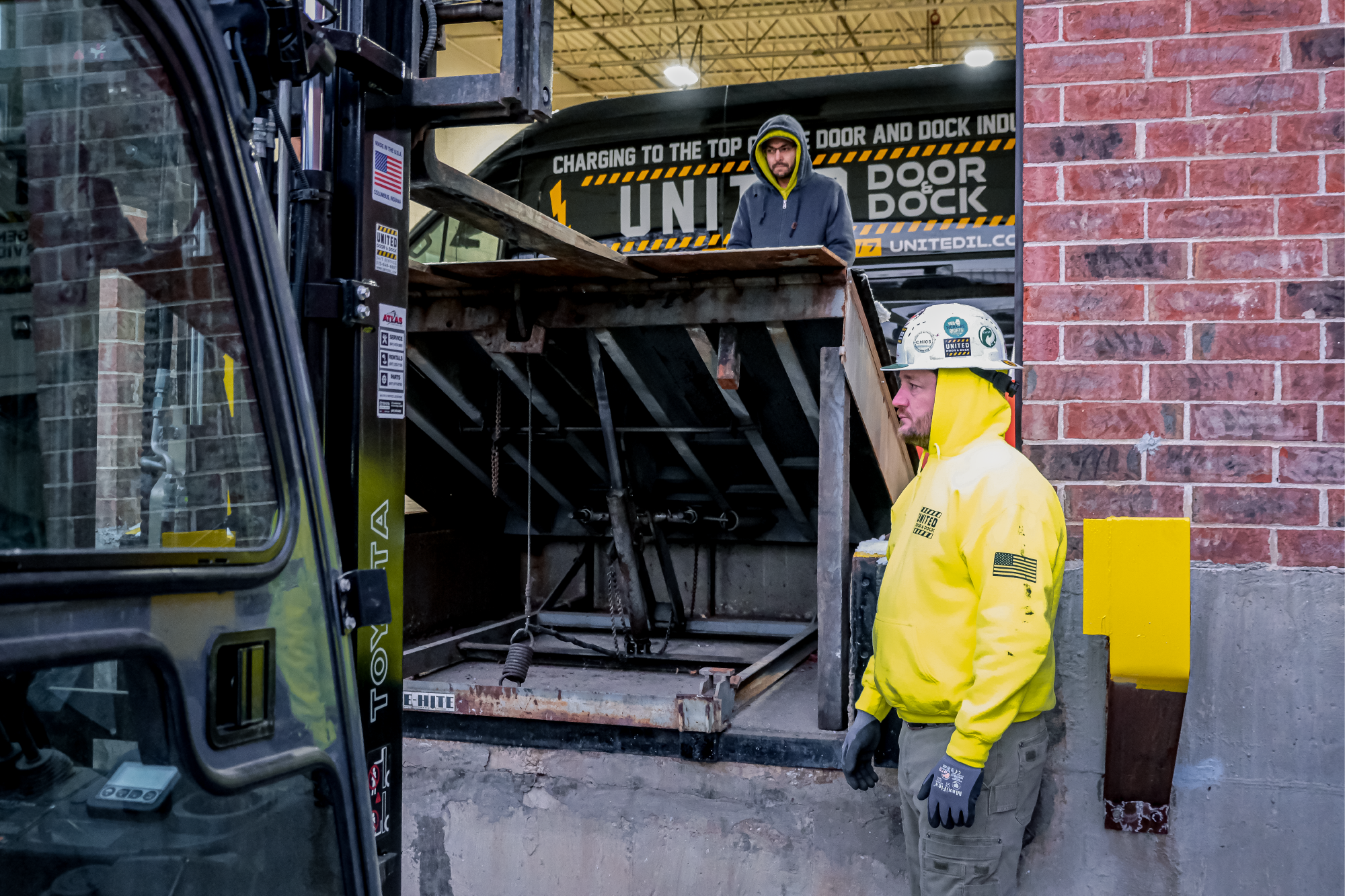 United Door and Dock Crew Members Working on Dock Lift