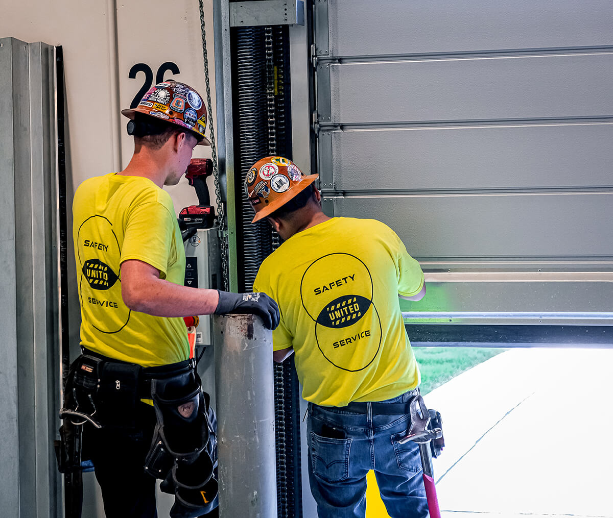 United Door and Dock Crew Members Working on Gray Hormann Commercial Overhead Door At Pace Bus