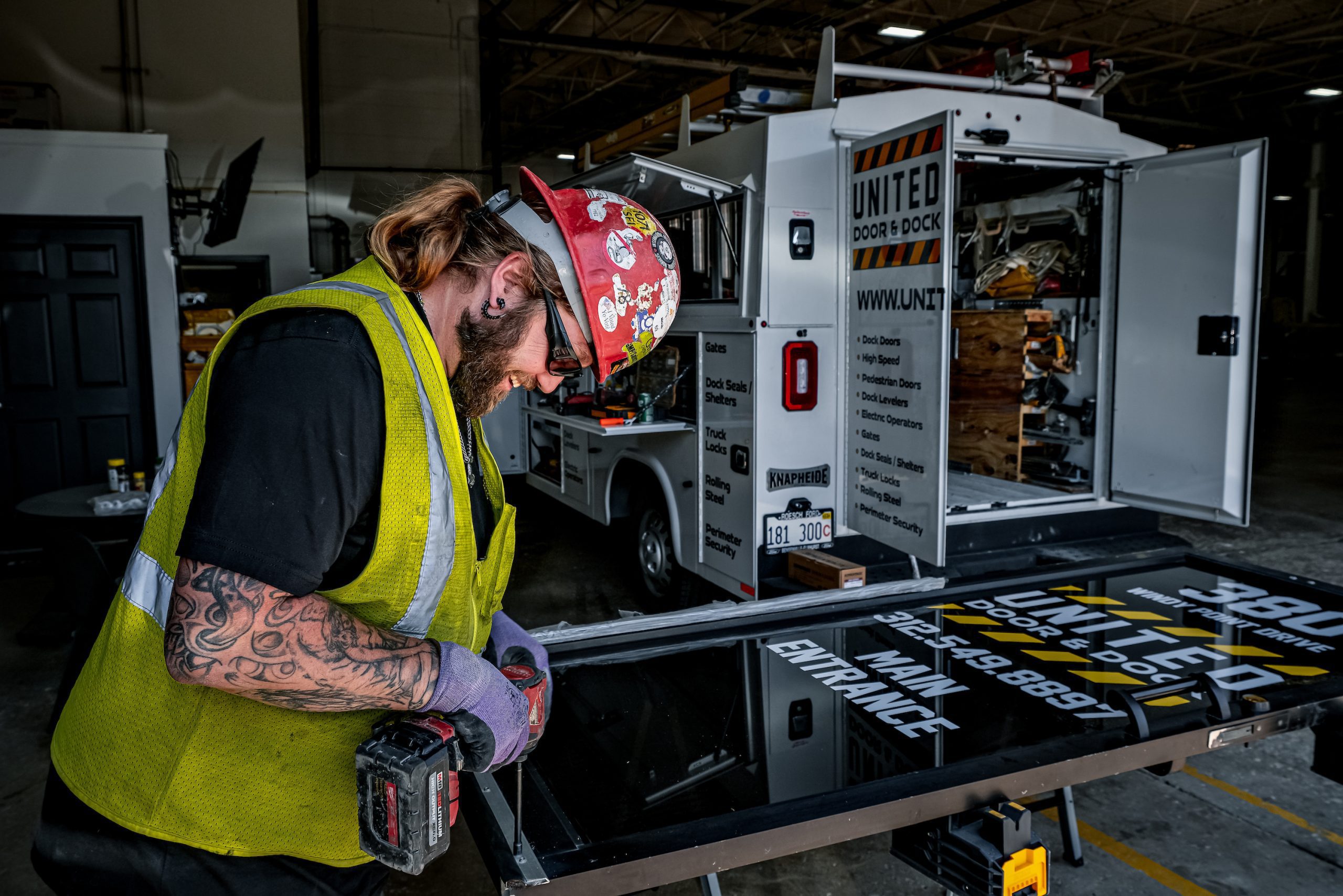 United Door and Dock Crew Member Working on Entrance Door